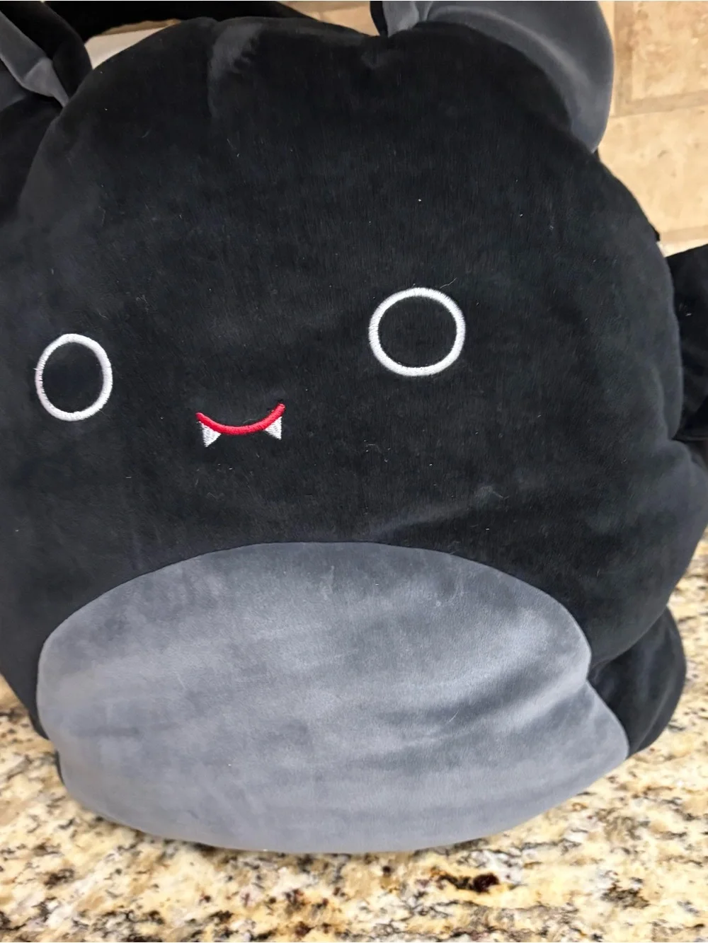 Squishmallows Black Plush Monster Backpack with Gray Belly and Red Smile